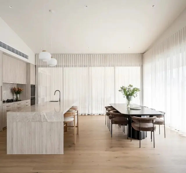 Waterfall stone island in the open kitchen and dining