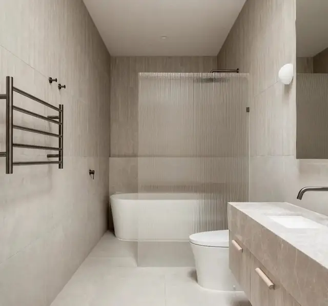 Skylit ensuite with a freestanding bath and floating vanity