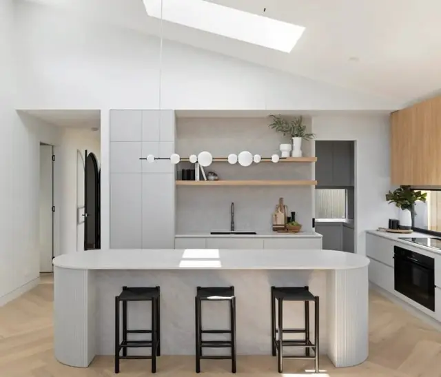Kitchen beneath the skylight, with a curved island