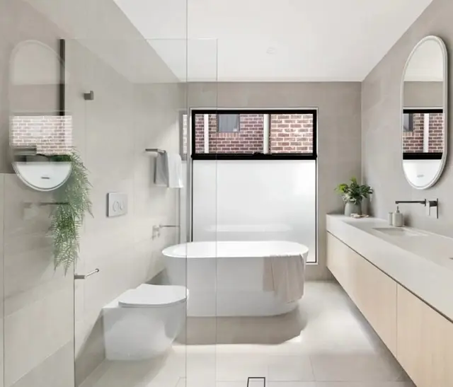 Main ensuite with a dual stone vanity and freestanding bath