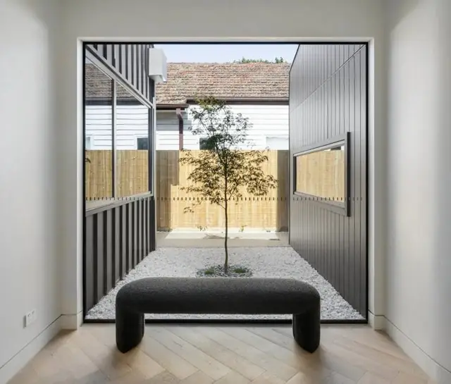 Courtyard outlook framed by full height glass