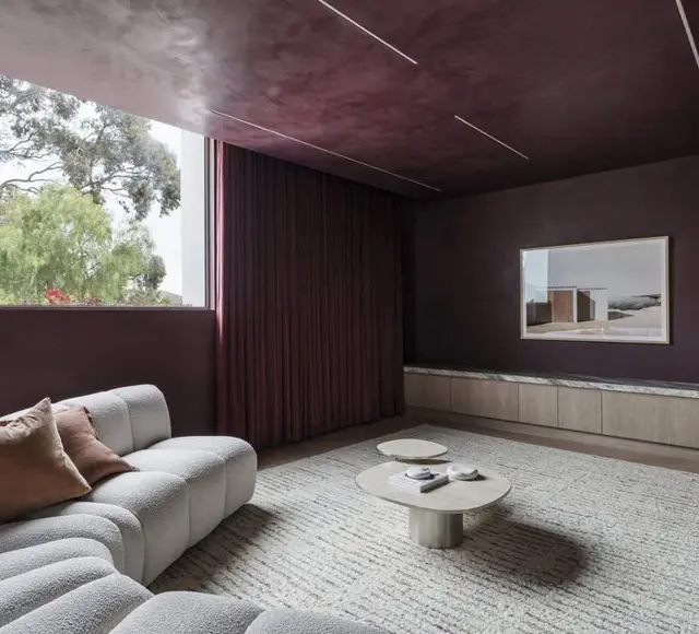 Deep oxblood feature wall in the main bedroom