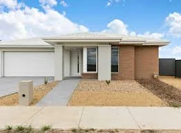 Brand new single storey rendered home at 14 Maxi Drive, Winter Valley, Victoria, with a garage and low maintenance gravel front garden